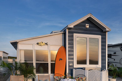 Small beach style blue two-story metal tiny house photo in Philadelphia with a hip roof and a metal roof