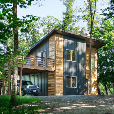 Example of a trendy multicolored two-story mixed siding house exterior design in Other with a shed roof