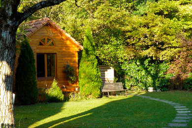 Small elegant one-story wood exterior home photo in Other