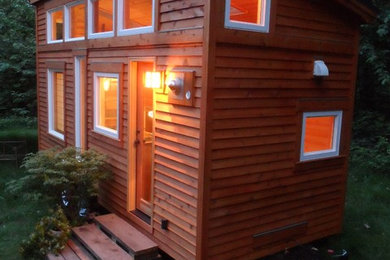 Immagine della casa con tetto a falda unica piccolo marrone etnico a un piano con rivestimento in legno