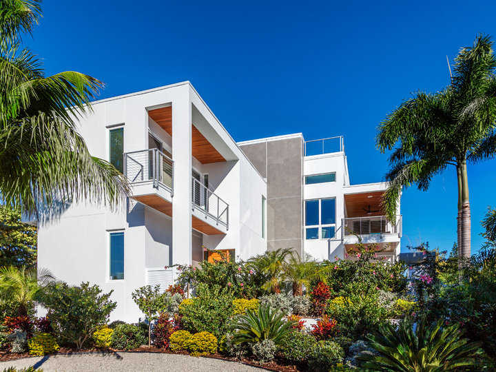 An illustration of a large, simple, two-story stucco exterior home design