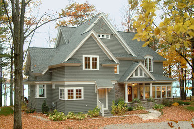 Example of a large arts and crafts gray two-story wood exterior home design in Other with a shingle roof