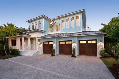 Inspiration for a large transitional blue two-story vinyl exterior home remodel in Miami