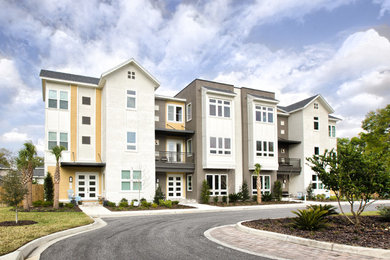 Large trendy brown three-story mixed siding exterior home photo in Other with a shingle roof