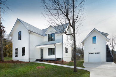 Example of a mid-sized country white two-story concrete fiberboard house exterior design in Other with a metal roof