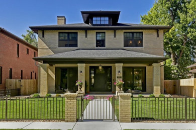 Inspiration for a large timeless beige two-story brick house exterior remodel in Denver with a shingle roof