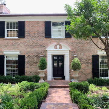 Traditional Brick Classic Home with White Trim and Black Shutters