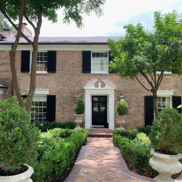 Traditional Brick Classic Home with White Trim and Black Shutters
