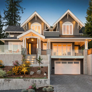 Inspiration for a large traditional two-storey grey house exterior in Vancouver with wood siding, a hip roof and a shingle roof.