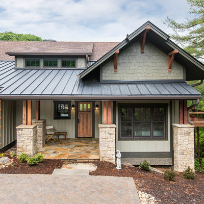 Inspiration for a mid-sized craftsman beige two-story wood exterior home remodel in Other with a mixed material roof