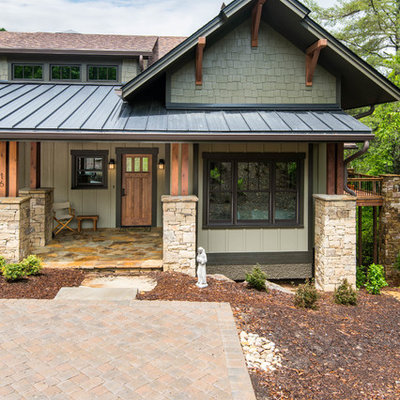 Mid-sized craftsman beige two-story wood exterior home idea in Other with a mixed material roof