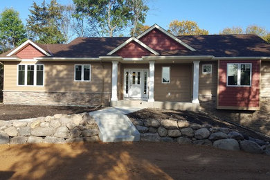 Mid-sized traditional beige one-story vinyl exterior home idea in Minneapolis with a shingle roof