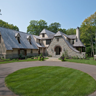 Inspiration for a timeless stone exterior home remodel in Minneapolis with a clipped gable roof