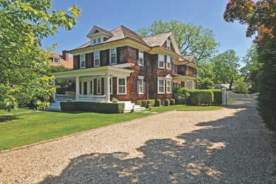 Example of a large classic red two-story wood exterior home design in New York