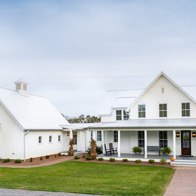 Inspiration for a large farmhouse white three-story concrete fiberboard exterior home remodel in Other with a metal roof