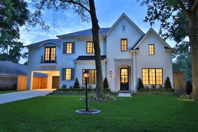 Large and white traditional two floor brick detached house in Houston with a pitched roof and a shingle roof.