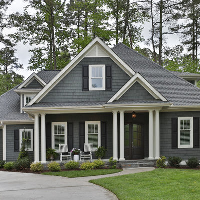 Inspiration for a large transitional gray two-story wood house exterior remodel in Raleigh with a hip roof and a shingle roof