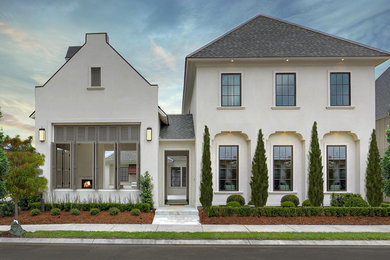Example of a transitional white two-story gable roof design in New Orleans with a shingle roof