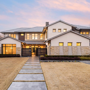 Transitional beige two-story mixed siding house exterior photo in Dallas with a hip roof and a metal roof