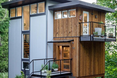 Mid-sized contemporary three-story mixed siding flat roof idea in Vancouver