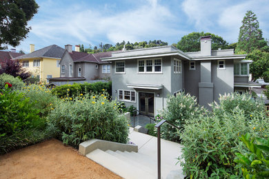 Example of a mid-sized transitional gray two-story stucco exterior home design in San Francisco with a mixed material roof