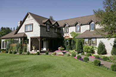 Example of a large classic gray two-story brick exterior home design in Minneapolis with a shingle roof