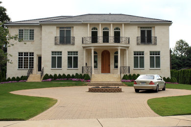Huge tuscan beige two-story stone house exterior photo in New York with a hip roof and a shingle roof