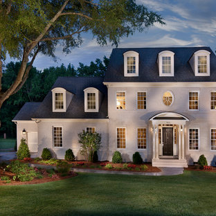 Example of a large classic white three-story brick exterior home design in Charlotte