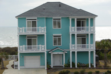 Inspiration for a large tropical blue three-story wood exterior home remodel in Other