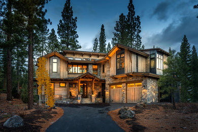 This is an example of a medium sized and gey rustic two floor house exterior in Sacramento with wood cladding.