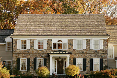 Traditional three-story stone gable roof idea in Philadelphia