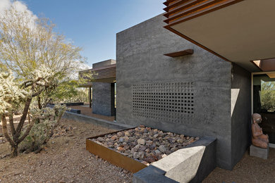 Trendy gray one-story concrete exterior home photo in Phoenix