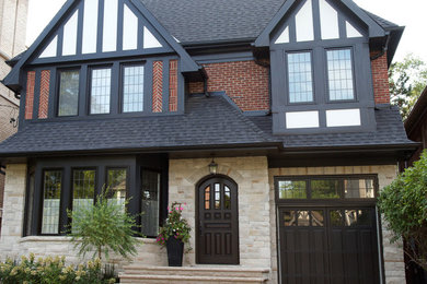 Example of a mid-sized classic multicolored two-story mixed siding exterior home design in Toronto with a shingle roof