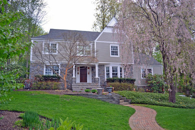 Photo of a medium sized and beige traditional two floor house exterior in New York with mixed cladding.