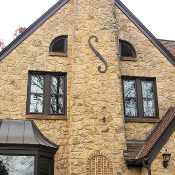 Tudor Revival Central Passage Home - Brown Gable Roof & Sand Color Stone Facing