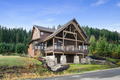Example of a mountain style brown three-story mixed siding exterior home design in Seattle with a shingle roof