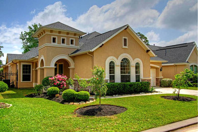Inspiration for a mid-sized beige one-story stucco exterior home remodel in Houston with a hip roof