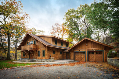 Example of a mid-sized mountain style two-story wood and shingle exterior home design in New York with a shingle roof and a black roof