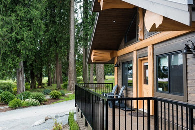 Mid-sized rustic brown one-story concrete fiberboard exterior home idea in Vancouver with a metal roof