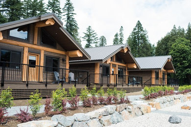 Inspiration for a mid-sized rustic brown one-story concrete fiberboard exterior home remodel in Vancouver with a metal roof