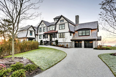 Inspiration for a large transitional white three-story wood exterior home remodel in Bridgeport with a shingle roof