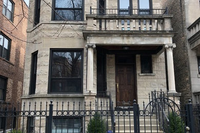 Example of a large classic gray two-story stone exterior home design in Chicago with a mixed material roof