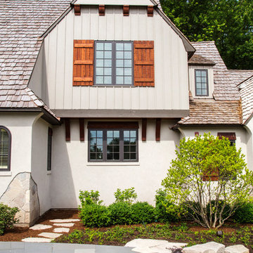 Two Story Front Element featuring Board and Batten Siding with Cedar Shake Roof
