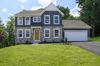 Example of a mid-sized transitional gray two-story stone exterior home design in Other with a shingle roof