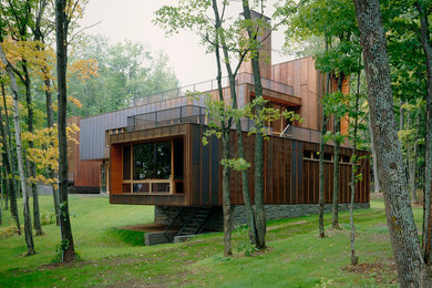 Inspiration for a large contemporary brown two-story metal flat roof remodel in Minneapolis