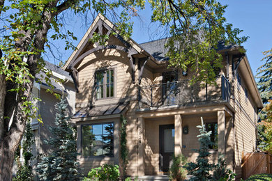 Example of a mid-sized mountain style brown three-story wood exterior home design in Calgary