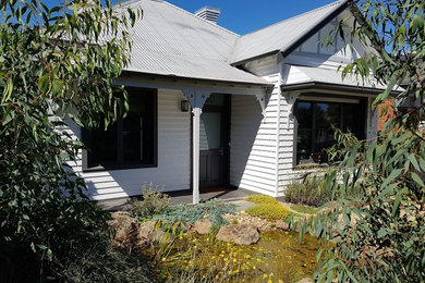 Design ideas for a white classic bungalow detached house in Melbourne with wood cladding, a pitched roof and a tiled roof.