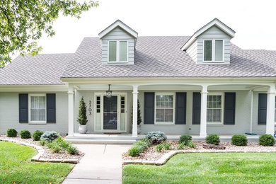 Mid-sized transitional gray two-story brick exterior home photo in Wichita with a shingle roof
