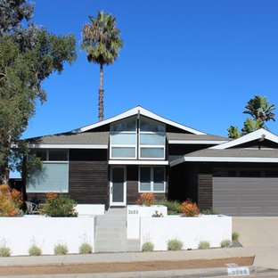 Design ideas for a mid-sized asian two-storey black house exterior in San Diego with wood siding, a hip roof and a shingle roof.