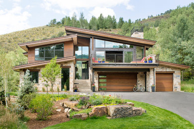 This is an example of a brown rustic two floor detached house in Denver with mixed cladding and a flat roof.